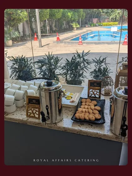Even a simple tea and coffee service is given a touch of elegance. This poolside setup includes tea and coffee urns alongside freshly baked cookies, perfect for a high-tea event or a break during a corporate meeting.