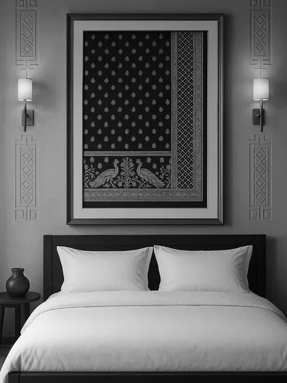 A framed Baluchari saree used as wall art above a bed, showcasing a creative way to incorporate handloom textiles.