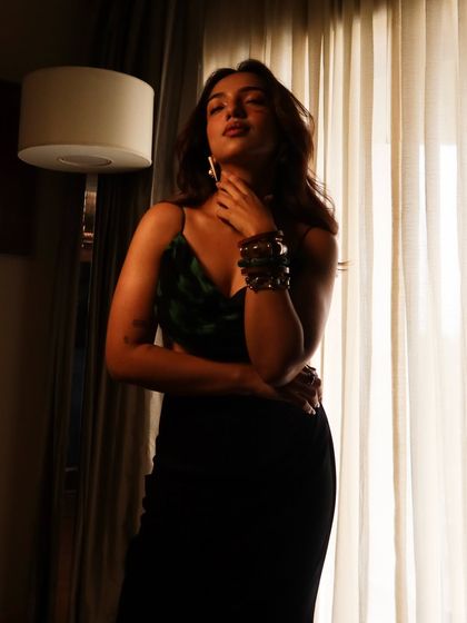 A moody, atmospheric shot of Ahsaas Channa for the 'Mismatched' promotions. The lighting and her pose create a sense of drama and intrigue.