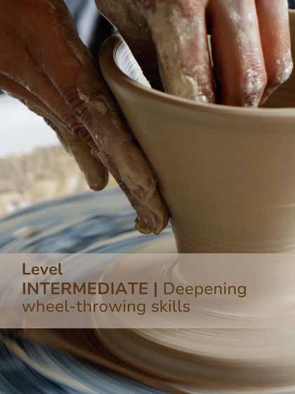 A close up of hands on the wheel, representing our intermediate level course focused on deepening wheel throwing skills and mastering more complex forms.