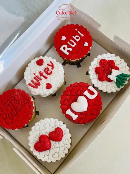 A box of six custom cupcakes designed to say "I love you." This romantic set features detailed fondant work with messages like "Wifey," "I ❤️ U," a bouquet of roses, and personalized names, making it a perfect anniversary or birthday gift.