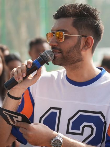 A close-up shot of me hosting the outdoor racing event, script in hand, ensuring I don't miss a single detail for the audience.