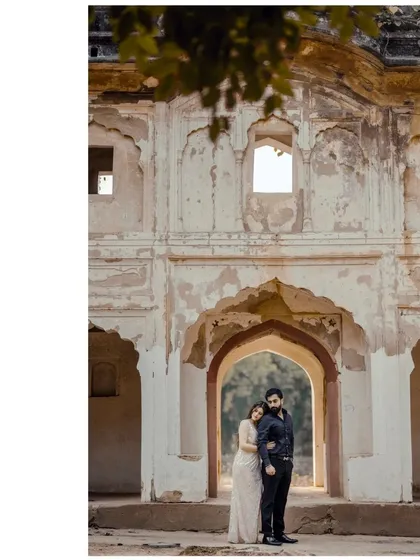 A tender moment framed by the weathered arch of a beautiful old ruin, highlighting the theme of timeless love.