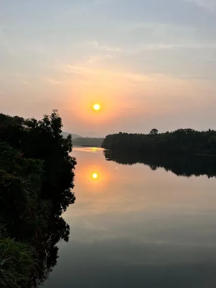 A stunning sunrise reflection over the Sharavathi backwaters in Honnavar.