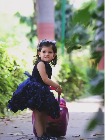 A little traveler on her way. The path and surrounding greenery create a sense of journey and adventure in this creative outdoor portrait.