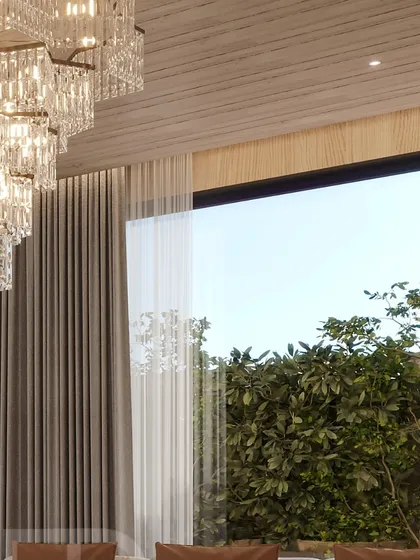 A detail of a crystal chandelier against a backdrop of lush greenery, illustrating the blend of luxury and nature.