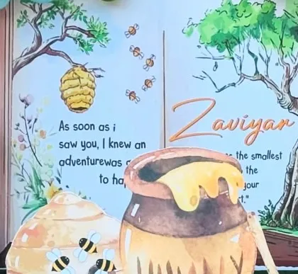 A close-up of the beautifully illustrated storybook backdrop, with custom text celebrating the birthday boy, Zaviyan.