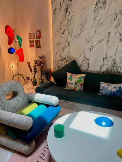We had so much fun creating this playful, postmodern armchair for a client in Hyderabad. The design features colorful, cylindrical cushions and a unique, sculptural form, set against a dramatic marble wall and a custom floor lamp, making it a true statement piece.