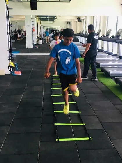 Consistency is key. Every drill, like this agility ladder exercise, is a step towards building lasting fitness habits and athletic confidence in a positive group setting.