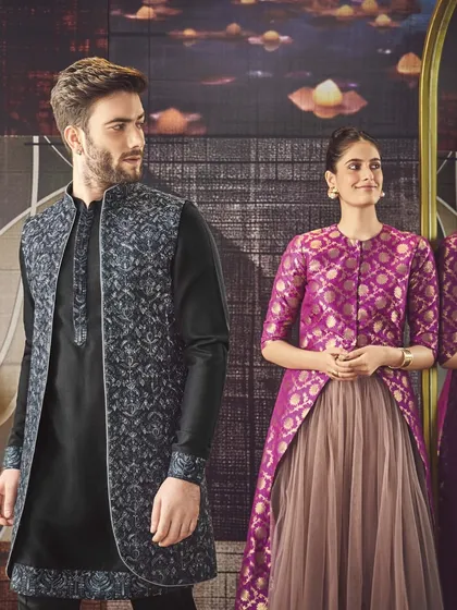 A dark kurta provides the perfect canvas for a textured, open-front jacket. This look showcases how we use layering to create depth and modern elegance.