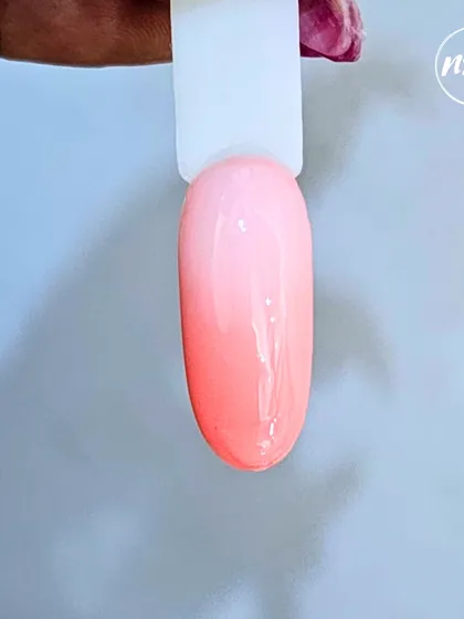 This is our temperature-change gel polish, a fun and innovative product from our line. It transitions from a soft peach to a vibrant pink based on temperature, creating a beautiful, subtle ombre effect.