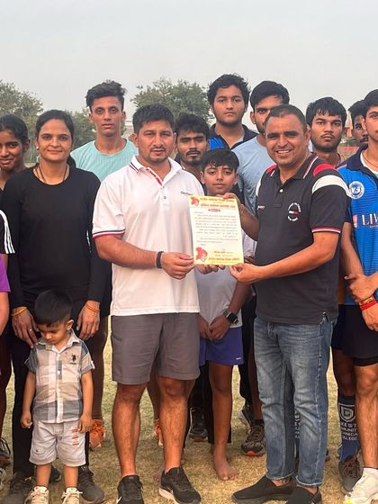 Posing with the team after receiving an invitation for a felicitation ceremony. An honor for me and my athletes.