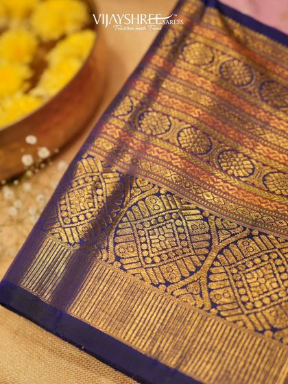 An incredibly detailed, heavy brocade pallu in blue and gold, showcasing the pinnacle of Kanjivaram weaving.