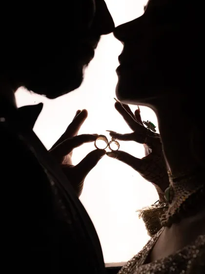 Sometimes, the most powerful images are the simplest. This silhouette shot focuses on the ultimate symbols of commitment, the rings, creating an intimate and artistic portrait that is all about their promise to each other.