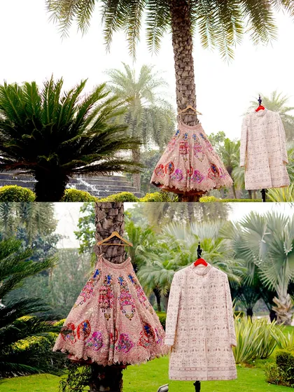 A creative shot of the bride and groom's wedding outfits hanging from a palm tree, showcasing them in a unique and artistic way.