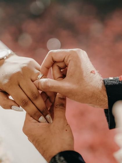 A close-up of the ring exchange, one of the most significant moments of an engagement ceremony.