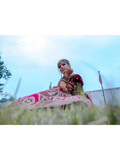 A creative low-angle shot from a bridal session. This perspective adds a sense of drama and grandeur, highlighting the bride against the open sky.