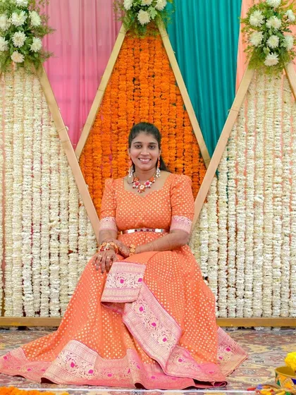 Another shot of our client in the beautiful orange Banarasi gown.