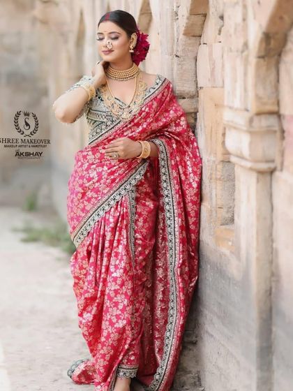 Another elegant pose in the pink Navvari saree, showcasing its rich fabric and traditional drape.