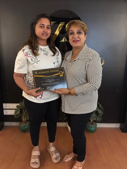A proud graduate holding her certificate after the Elleza Lash Extension workshop.