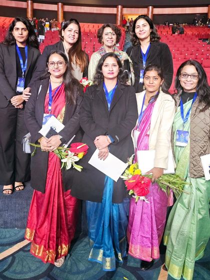 A group photo with other attendees and dignitaries at the NCW event.