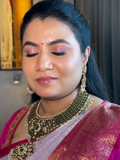 A beautiful example of my skin-like finish makeup. This look features soft pink eyeshadow and a glossy lip, creating a fresh and radiant effect for this traditional South Indian style.