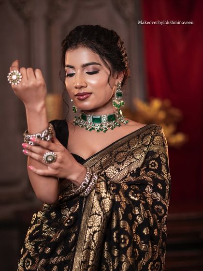 Another shot of the elegant black saree look, showcasing the beautiful jewelry.