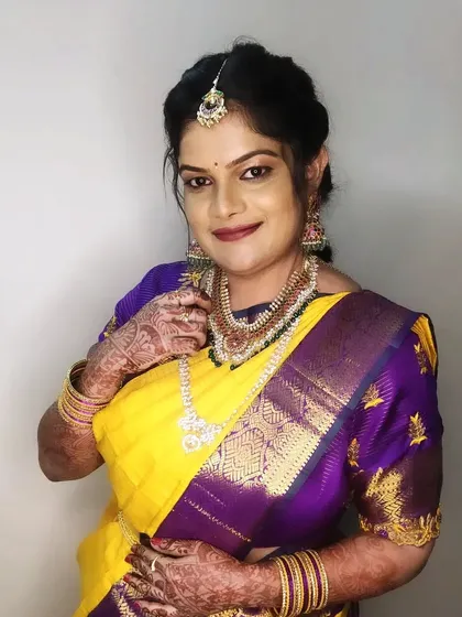 A happy and confident portrait of Pratima, showcasing the complete traditional look for a family wedding.
