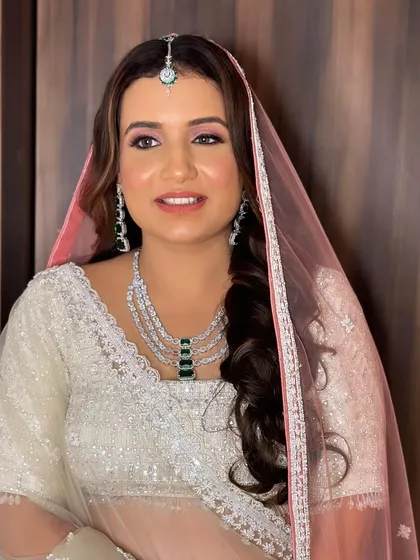 A side view of Annie's wedding look. The soft pink eyeshadow adds a touch of romance and ties in with her pink dupatta.