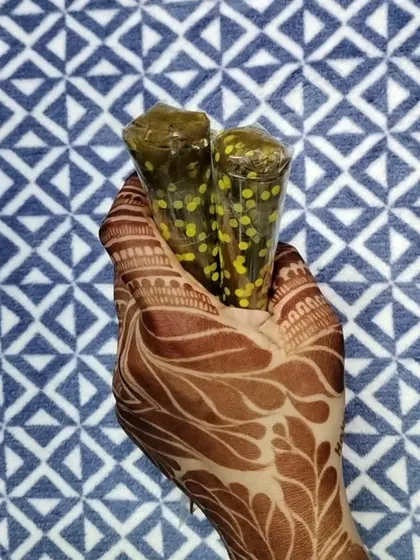 Holding the tools of the trade. The rich, dark stain on my hand is a direct result of this very henna paste.