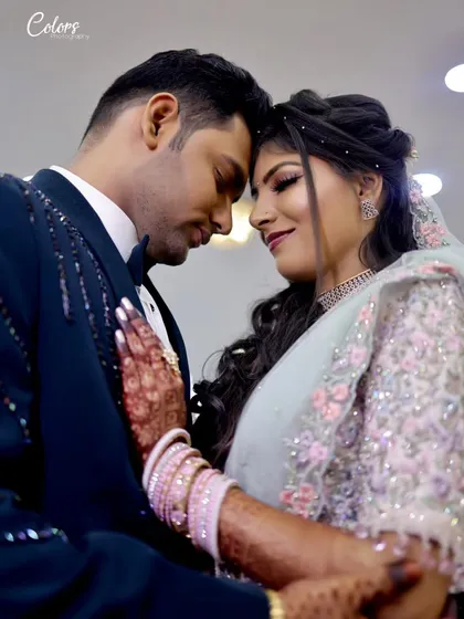 An intimate portrait of the couple, their foreheads touching, capturing a quiet moment of connection during their reception.