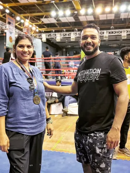 With a fellow coach and champion at the Kickboxing National Championship. It's great to connect with other strong women in the sport.