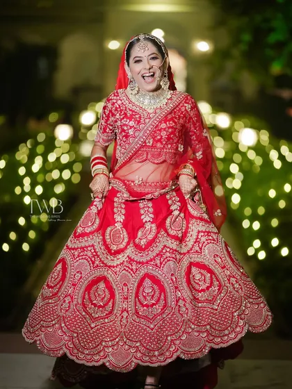 A wedding is a festival of joy, and we love capturing the bride's unfiltered happiness. This candid shot of a bride twirling with a huge smile shows the personality and pure bliss that we believe makes the best photographs. No poses, just real emotions.