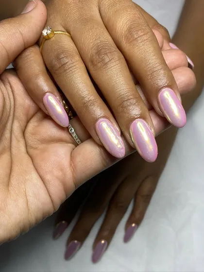 Another view of the unicorn chrome nails, held to showcase the color shift and shine.