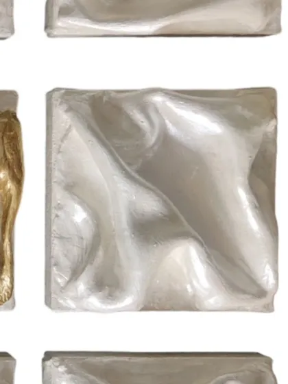 A detail of one of the all-silver dancers. Their surfaces swirl in graceful, unified steps, blending into a seamless choreography of light and shadow.
