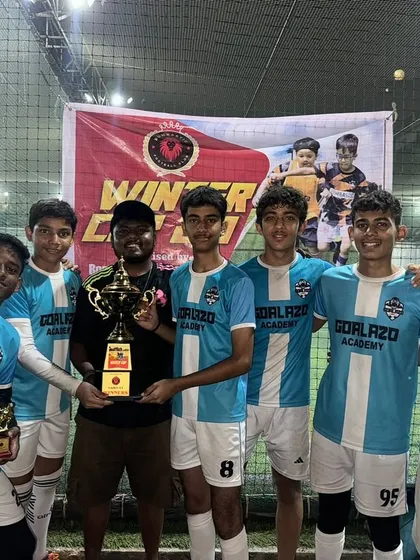The victorious Under-15 team with their coach and the winner's trophy after a successful campaign at the Winter Cup.