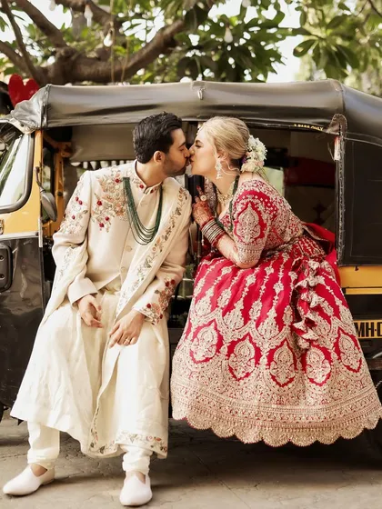 Ending the wedding day with a classic Mumbai twist. This fun, quirky portrait of the couple sharing a kiss on an auto-rickshaw perfectly captures their playful spirit and the vibrant city where their story unfolded.