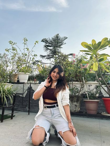 A fun, kneeling pose in a Myntra outfit. This shows my playful side and makes the content more engaging.