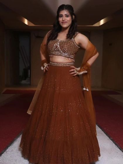 Posing in a beautiful embellished lehenga. It's important to celebrate life's joyful moments.