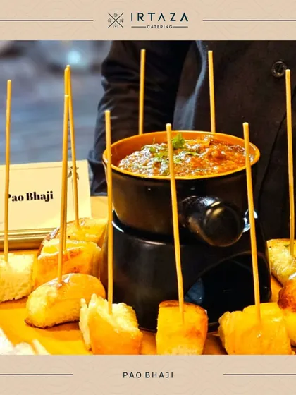 Pao Bhaji served fondue-style. Toasted bread cubes on skewers are ready to be dipped into a hot pot of flavorful bhaji, making this classic street food interactive and fun.