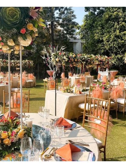 A stunning outdoor brunch setup with tables dressed in peach and adorned with vibrant floral centerpieces. This image highlights our expertise in creating beautiful daytime events with a fresh and celebratory feel.