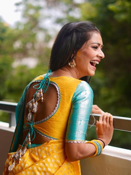 Our client, actress Leena Gowda, looking fearlessly authentic in her custom yellow and turquoise Sacaru saree blouse with a stylish back cutout.