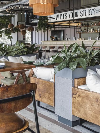 We created comfortable lounge seating pockets for a more intimate experience. These areas, furnished with plush cushions and surrounded by greenery, invite guests to relax and enjoy the space at their leisure.