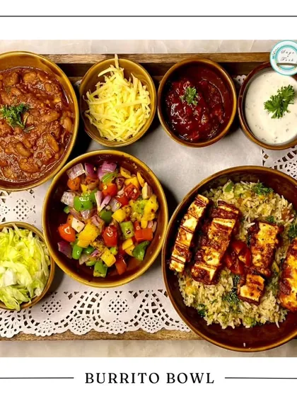 My Burrito Bowl platter is a unique and hearty option for a festive meal. It's a deconstructed bowl with cilantro lime rice, grilled paneer, beans, salsa, and cheese, perfect for a modern Rakhi feast.
