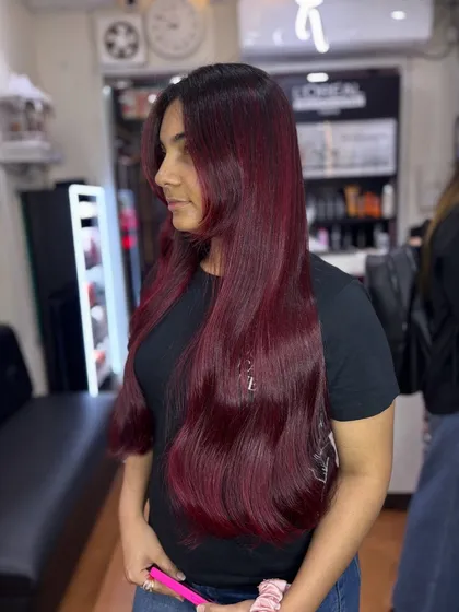A side view of the cherry red magic. The color is rich and consistent from root to tip, which is the hallmark of a professional color application.