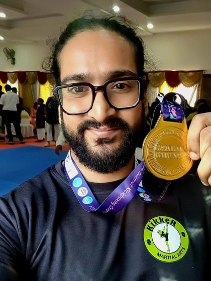 Coach Chirag with his gold medal from the district championships. Leading by example and inspiring our students.