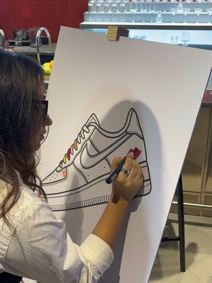 A guest colors in a section of the large art canvas. This activity provides a great photo opportunity and a relaxed way for attendees to engage with our brand and the event.