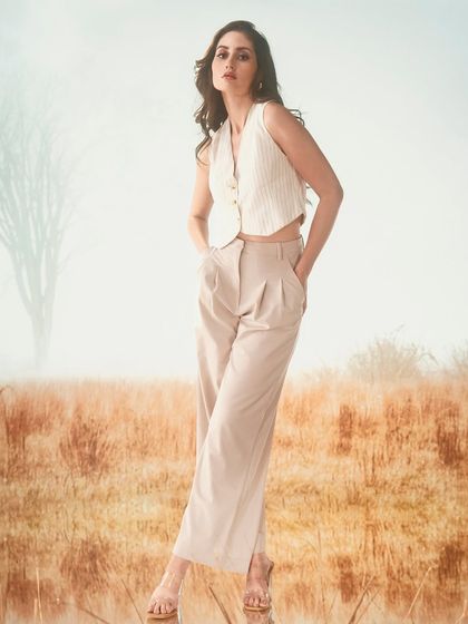 A misty, open field with a lone tree, created with projection. The soft, diffused light of the projected scene creates a serene and minimalist backdrop for this chic, neutral-toned outfit.