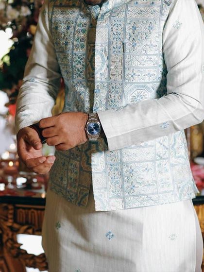 A close-up of the geometric-patterned bundi, highlighting the intricate weave and the sophisticated color palette.