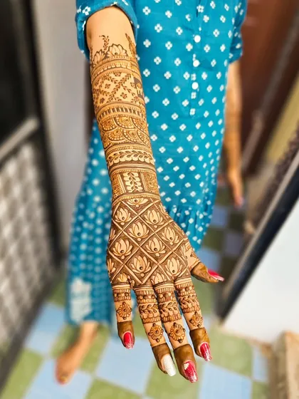 A full-arm view of a design featuring lotus grids and traditional motifs.